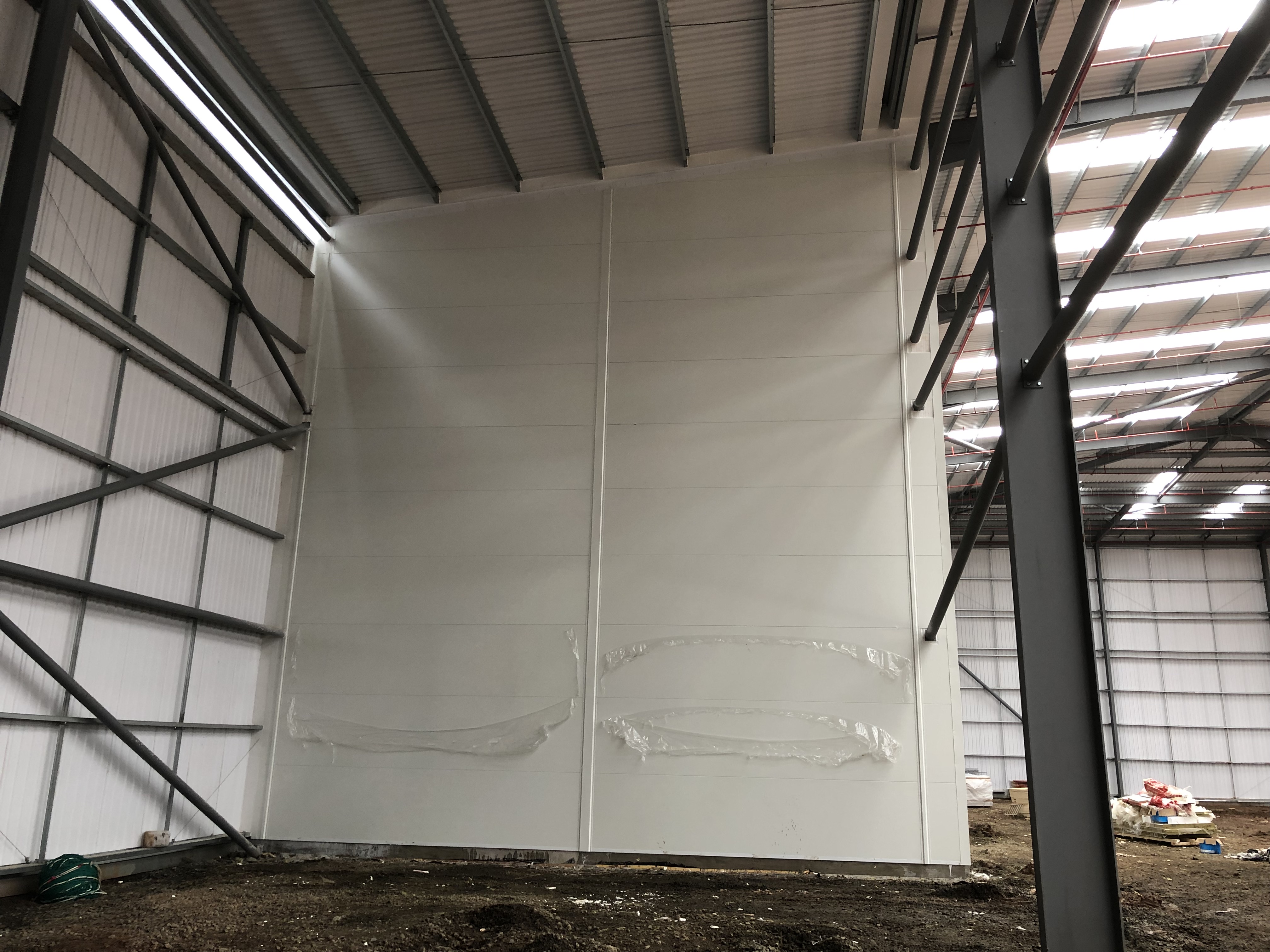 Fire-rated compartmentation wall under construction within industrial building